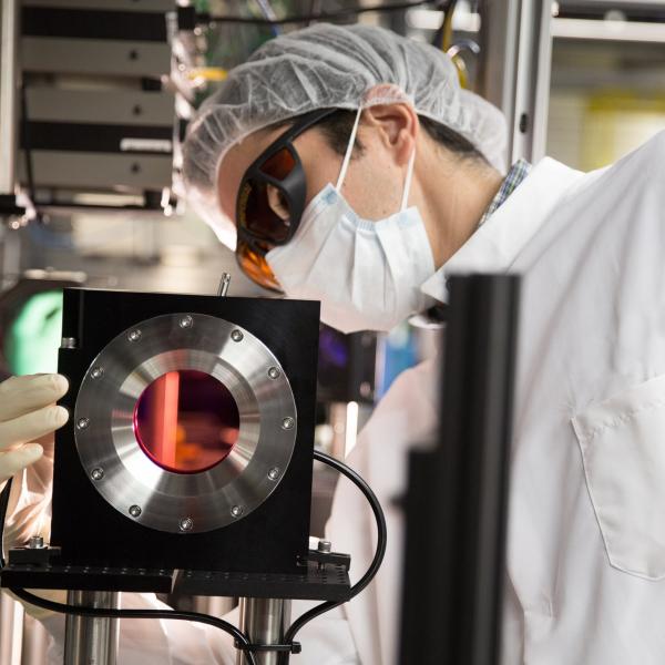 Image - Eduardo Granados inspects a large titanium sapphire crystal, the operative component in a newly upgraded high-power laser system that is designed to work in conjunction with a unique X-ray laser at SLAC.