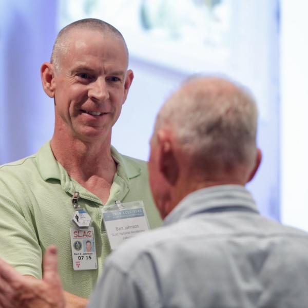 Image - Bart Johnson of SLAC's Stanford Synchrotron Radiation Lightsource is congratulated by X-ray science luminary Farrel W. Lytle after receiving an annual award. (SLAC National Accelerator Laboratory)